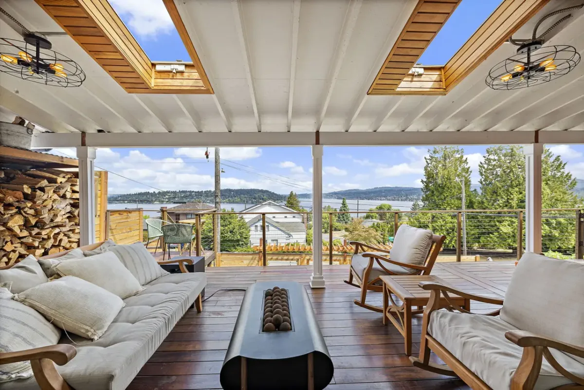 Covered lounge with skylights and lake view at The Lucille Lake Washington View Retreat